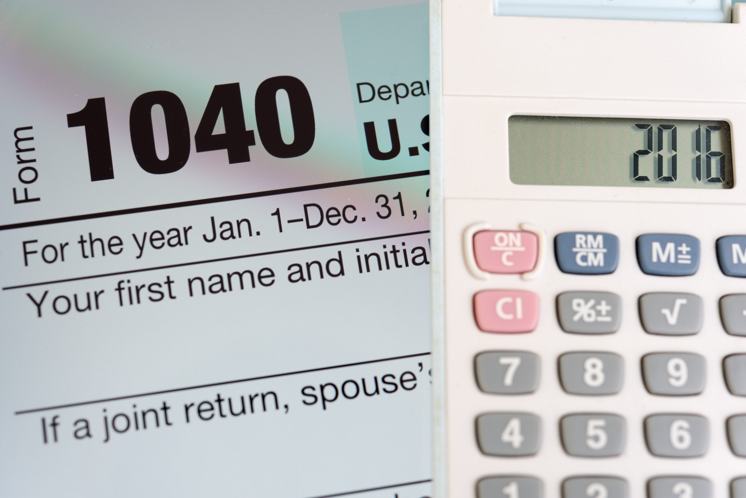 Tax forms, tablet, and calculator — bank statement loans skip tax returns and qualify Texas self-employed borrowers on real cash flow