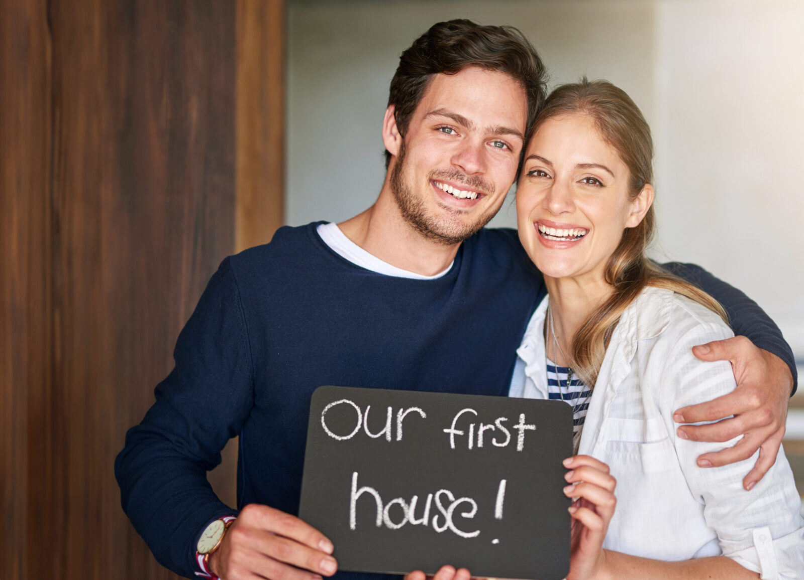 Couple celebrating outside their newly purchased Cibolo, Texas home