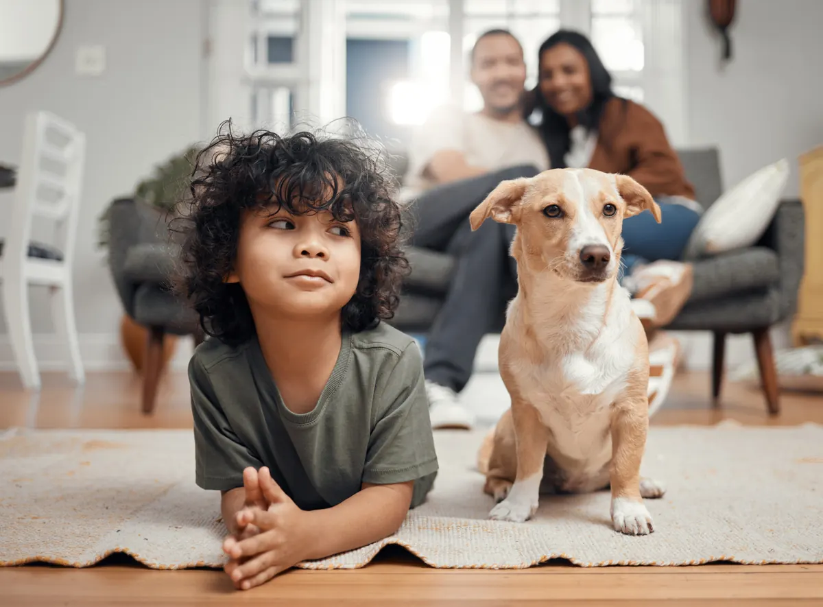 Happy Texas family relaxing at home with their dog — Texas mortgage broker Adam Bartling helps families achieve homeownership